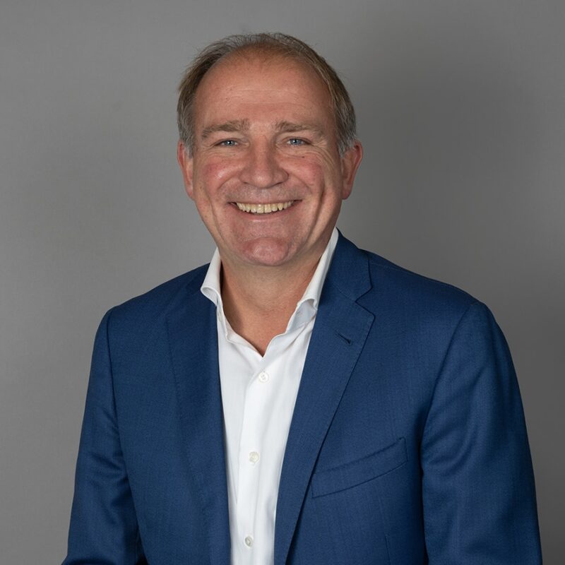 Smiling middle-aged man in blue blazer and white shirt