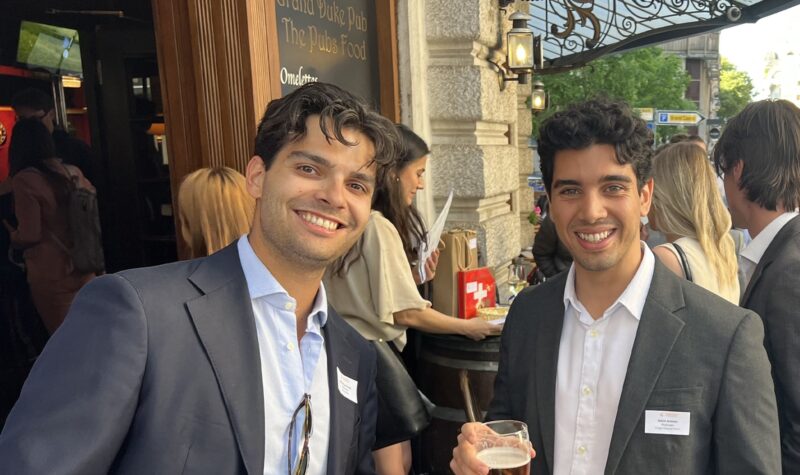 Two smiling men in suits at Grand Duke Pub networking event