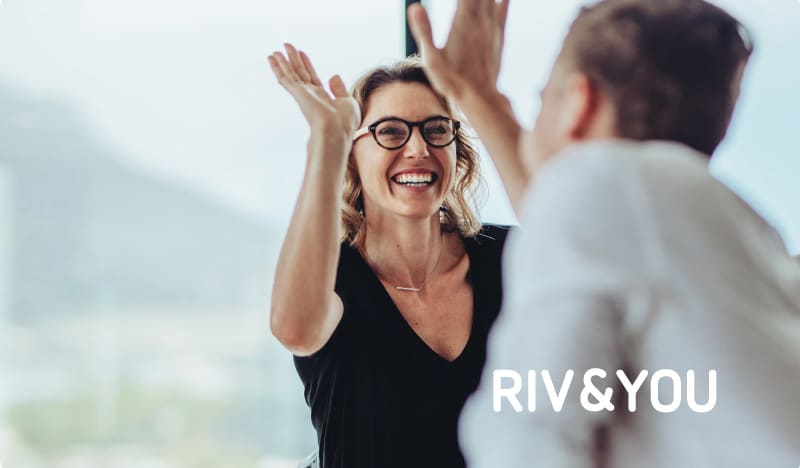 Two colleagues celebrating with a high five at RIV&YOU