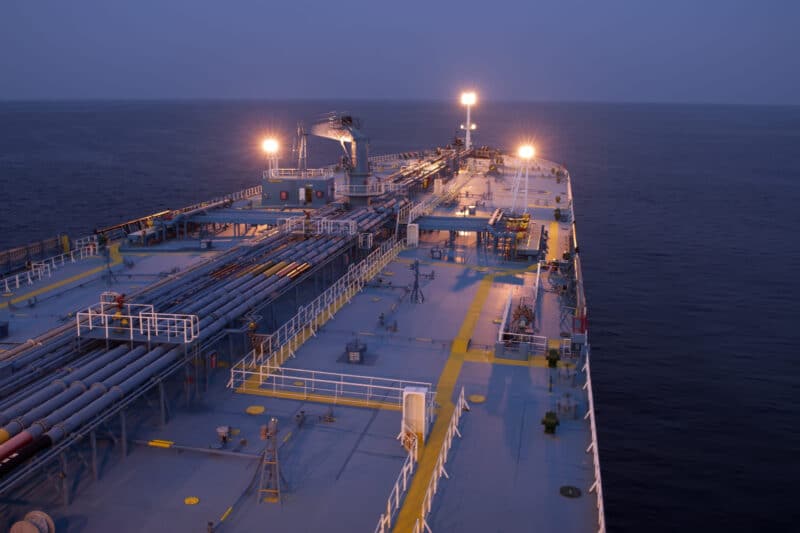 Large oil tanker ship deck at dusk on open ocean