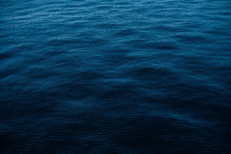 Deep blue ocean water surface with gentle rippling waves