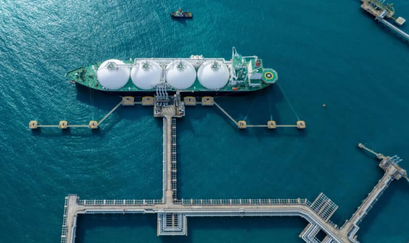 Aerial view of LNG tanker ship docked at offshore terminal